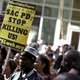 Black Lives Matter protesters hold signs as they stage a demonstration outside Sacramento (Calif.) City Hall on March 22, 2018.